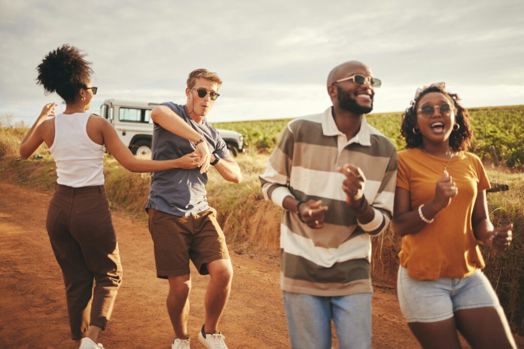 Freedom, travel and dance with friends on road trip in countryside for party, summer and celebratio